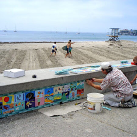 Ceramics being added to a wall that were made at a fundraiser event hosted at Petroglyph.