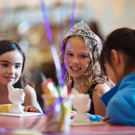 Three kids enjoying a fun birthday party at Petroglyph Sacramento.
