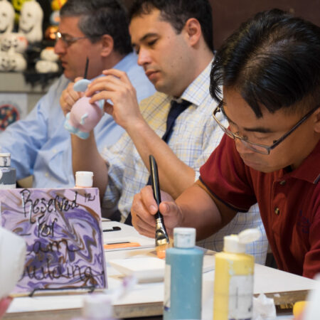 Team members getting creative with ceramics at team building event hosted at Petroglyph.